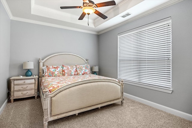 bedroom featuring crown molding, carpet flooring, a tray ceiling, and visible vents