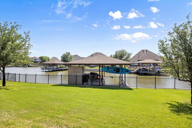view of yard with fence and a water view