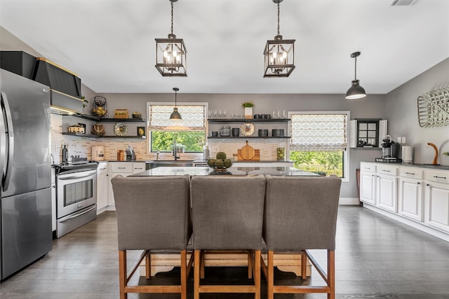 kitchen with stainless steel appliances, open shelves, backsplash, white cabinetry, and dark wood-style flooring