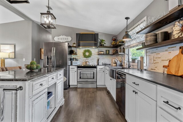 kitchen featuring backsplash, lofted ceiling, open shelves, appliances with stainless steel finishes, and premium range hood