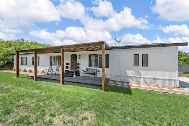 rear view of property featuring a yard