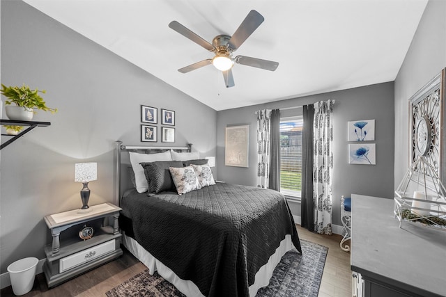 bedroom featuring vaulted ceiling, wood finished floors, and a ceiling fan