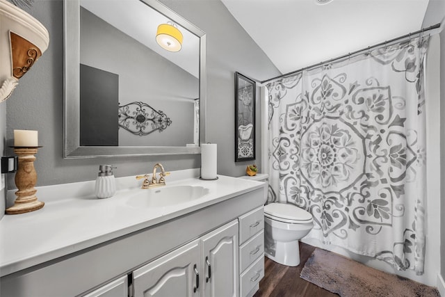 full bathroom featuring shower / bath combo, toilet, lofted ceiling, wood finished floors, and vanity