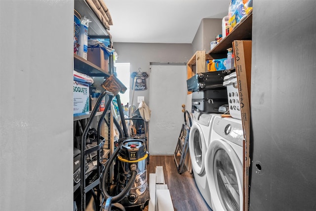 laundry room featuring separate washer and dryer, wood finished floors, and laundry area