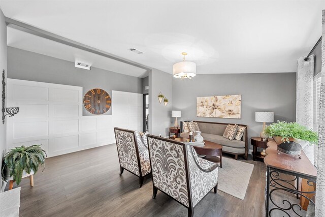 living area with wood finished floors and visible vents