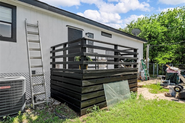 exterior space with central AC unit and fence