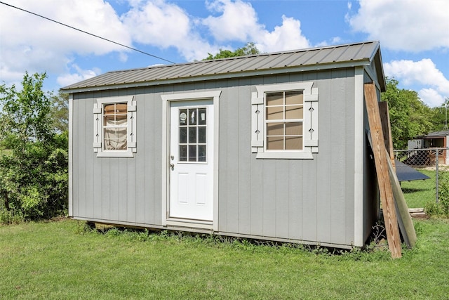 view of shed featuring fence