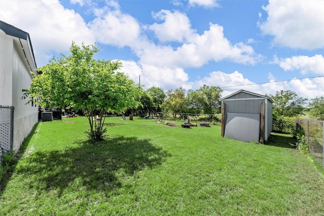 view of yard featuring a fenced backyard, an outdoor structure, and a storage shed