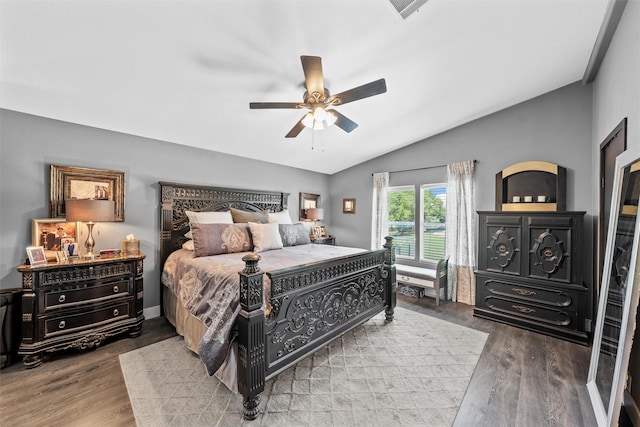 bedroom with lofted ceiling, visible vents, a ceiling fan, and wood finished floors