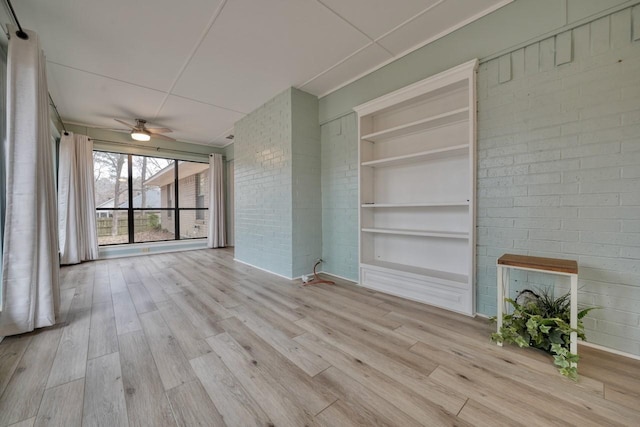 1208 Lake Cross Rd, Hideaway, TX 75771 - unfurnished living room featuring built in shelves, a ceiling fan, and wood finished floors