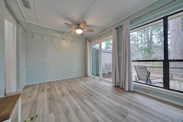 1208 Lake Cross Rd, Hideaway, TX 75771 - unfurnished room with brick wall, visible vents, wood finished floors, and ceiling fan