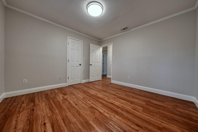 1208 Lake Cross Rd, Hideaway, TX 75771 - unfurnished bedroom with baseboards, wood finished floors, and visible vents