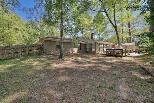 1208 Lake Cross Rd, Hideaway, TX 75771 - rear view of house with brick siding, a chimney, fence, and a deck