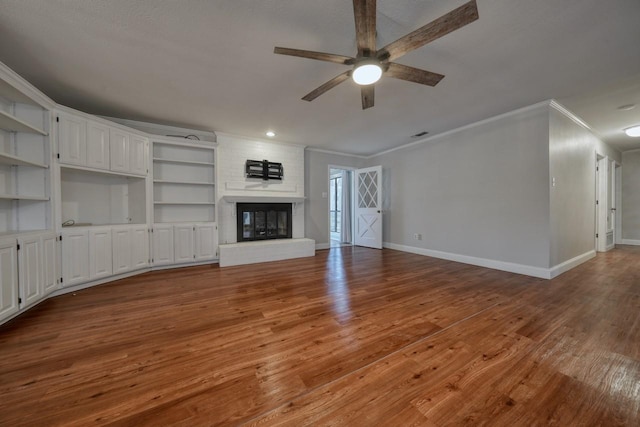 1208 Lake Cross Rd, Hideaway, TX 75771 - unfurnished living room with ceiling fan, baseboards, ornamental molding, and wood finished floors