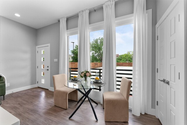 dining room with baseboards, recessed lighting, and wood finished floors