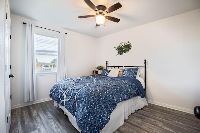 bedroom featuring ceiling fan, baseboards, and wood finished floors