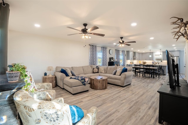 living room featuring recessed lighting, light wood finished floors, and a ceiling fan