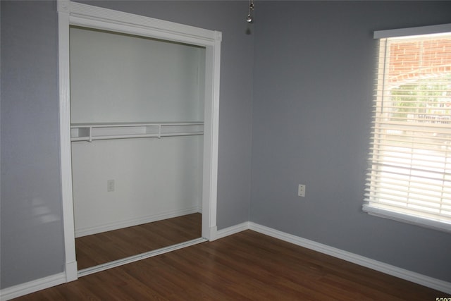1916 Grainger St, Fort Worth, TX 76110 - unfurnished bedroom featuring a closet, wood finished floors, and baseboards