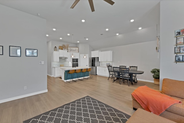 living area featuring recessed lighting, ceiling fan, baseboards, and light wood-type flooring