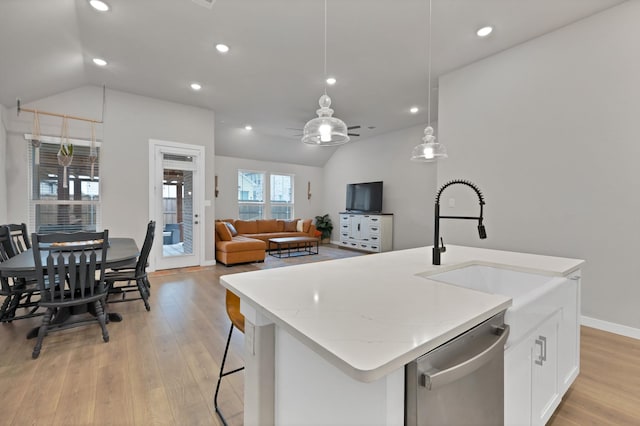 1373 Silverthorn Trl, Justin, TX 76247 - kitchen with stainless steel dishwasher, lofted ceiling, light wood-type flooring, a ceiling fan, and recessed lighting