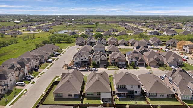 birds eye view of property with a residential view and a water view