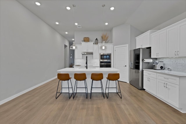 1373 Silverthorn Trl, Justin, TX 76247 - kitchen with stainless steel appliances, under cabinet range hood, tasteful backsplash, white cabinets, and recessed lighting