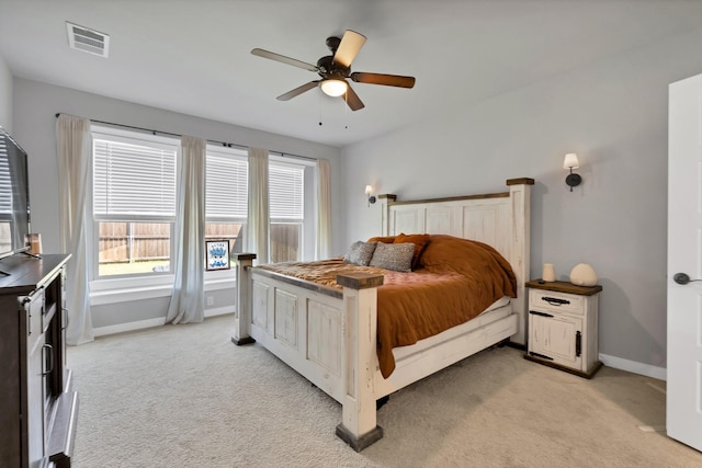 bedroom featuring light colored carpet, ceiling fan, baseboards, and visible vents