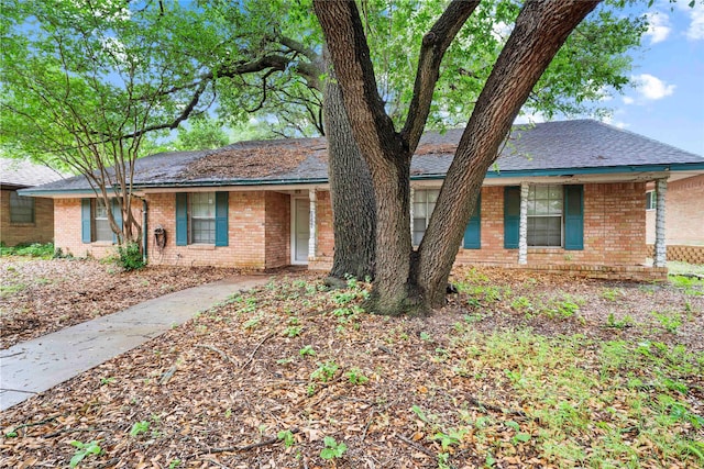 single story home featuring brick siding