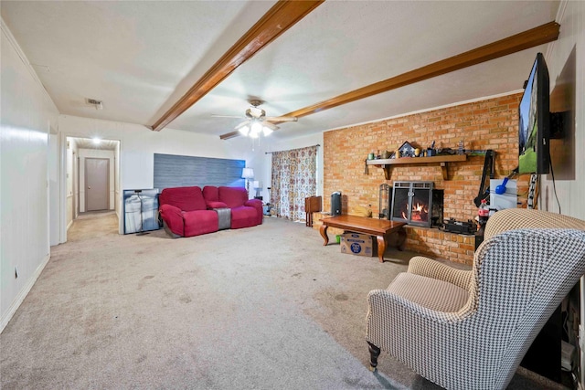 living room featuring beamed ceiling, ceiling fan, carpet, and a brick fireplace