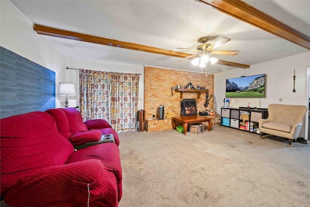 carpeted living area with beamed ceiling, a ceiling fan, and a brick fireplace