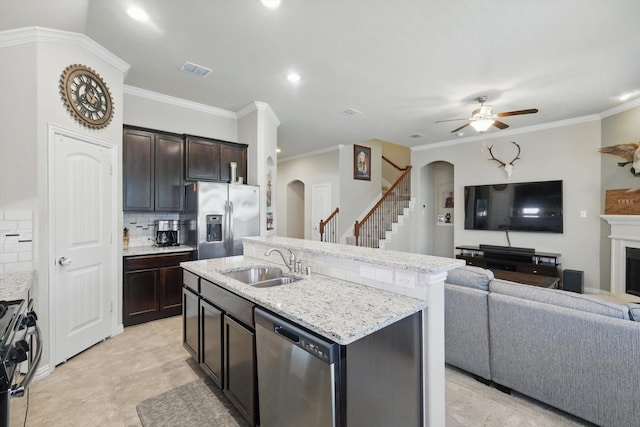 1325 Zanna Grace Way, Fort Worth, TX 76052 - kitchen featuring arched walkways, stainless steel appliances, a sink, open floor plan, and crown molding