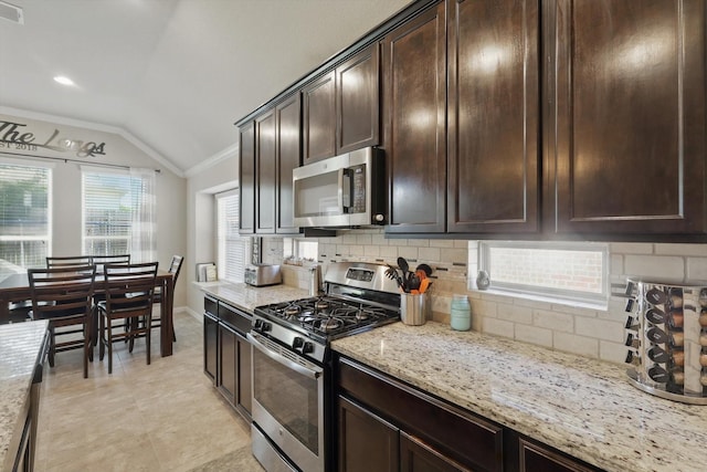 1325 Zanna Grace Way, Fort Worth, TX 76052 - kitchen featuring stainless steel appliances, lofted ceiling, crown molding, backsplash, and dark brown cabinetry