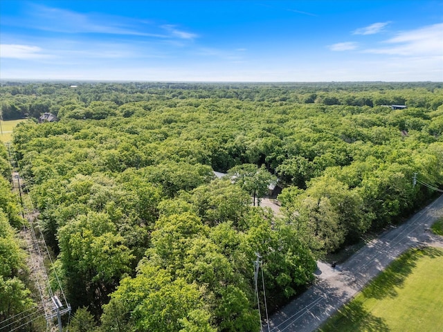 drone / aerial view with a wooded view