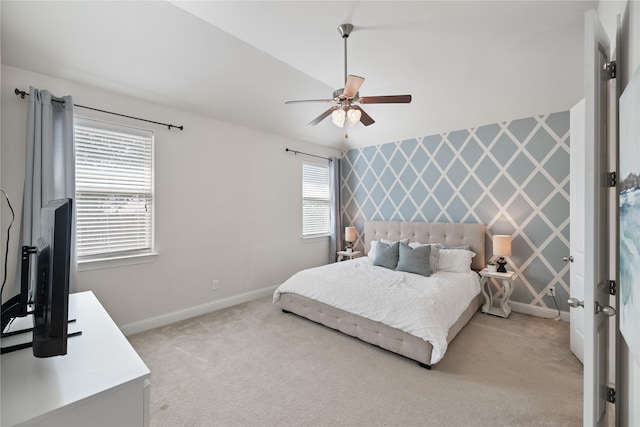 bedroom featuring light carpet, baseboards, and ceiling fan