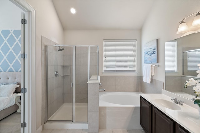 ensuite bathroom featuring a shower stall, ensuite bath, and a garden tub