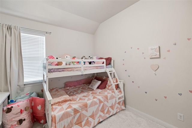 bedroom with carpet floors, lofted ceiling, and baseboards