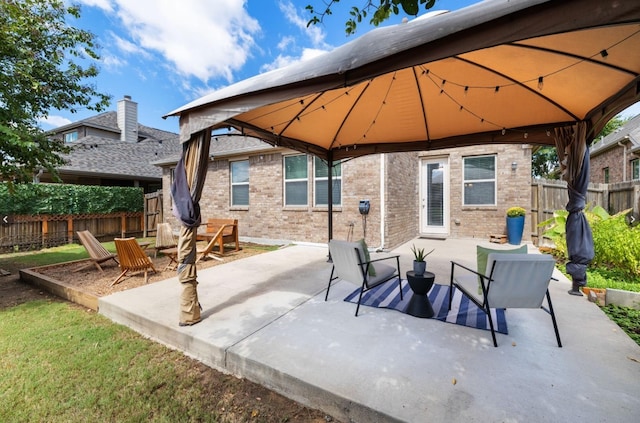 view of patio with a gazebo and fence