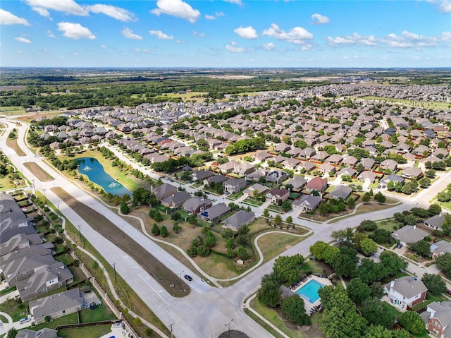 drone / aerial view featuring a residential view and a water view