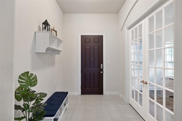 mudroom with baseboards, french doors, and light tile patterned floors