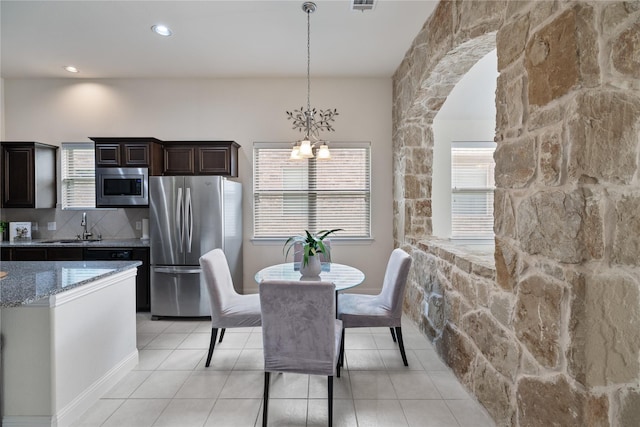 dining area featuring recessed lighting, visible vents, light tile patterned floors, and an inviting chandelier