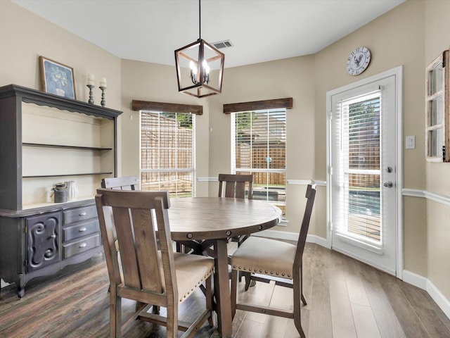 1803 Timber Ridge Dr, Frisco, TX 75036 - dining space featuring a chandelier, healthy amount of natural light, baseboards, and wood finished floors