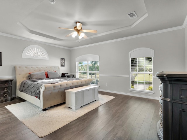 1803 Timber Ridge Dr, Frisco, TX 75036 - bedroom with a tray ceiling, dark wood-style flooring, ceiling fan, crown molding, and baseboards