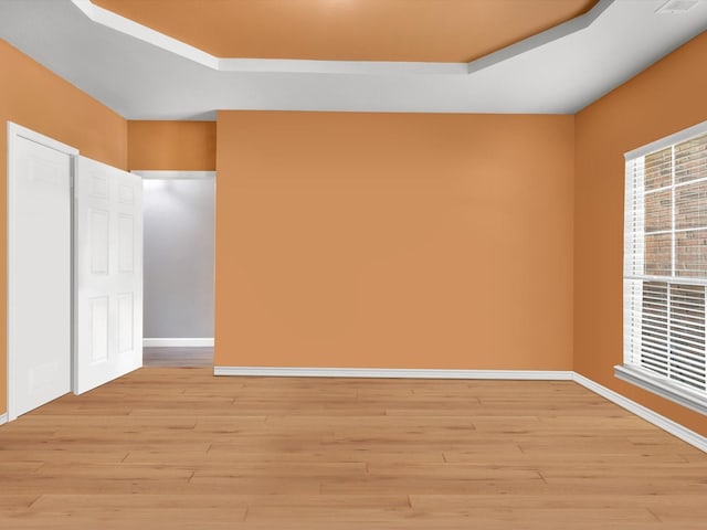 1803 Timber Ridge Dr, Frisco, TX 75036 - empty room featuring a raised ceiling, light wood-style floors, and baseboards