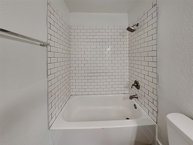 bathroom with shower / bath combination and toilet