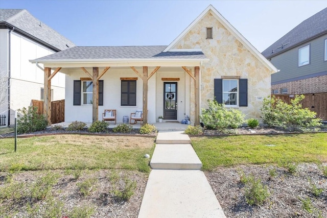 14405 Walsh Ave, Fort Worth, TX 76008 - view of front facade with a porch, stone siding, and roof with shingles