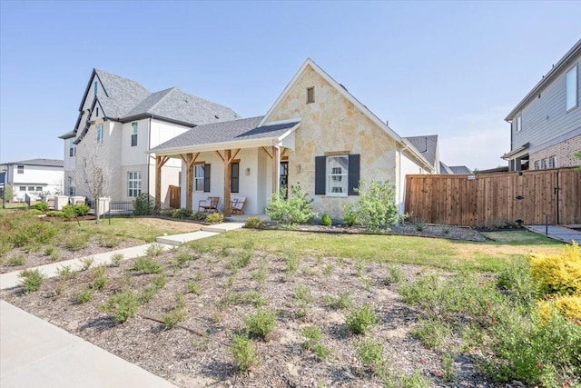 14405 Walsh Ave, Fort Worth, TX 76008 - view of front of home featuring fence, stone siding, and stucco siding