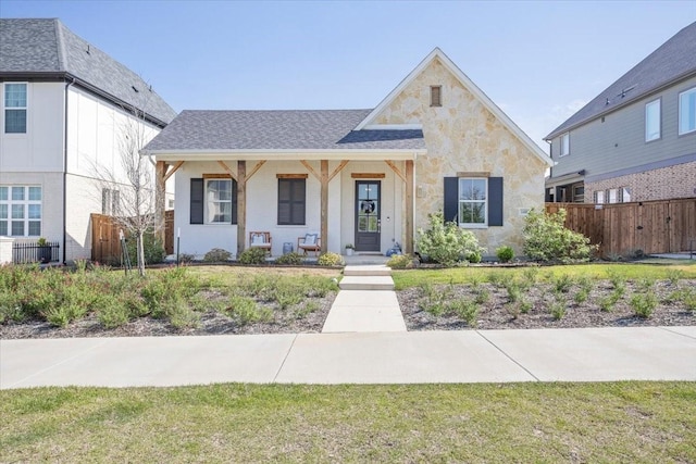 14405 Walsh Ave, Fort Worth, TX 76008 - view of front of home featuring fence, a porch, and stone siding
