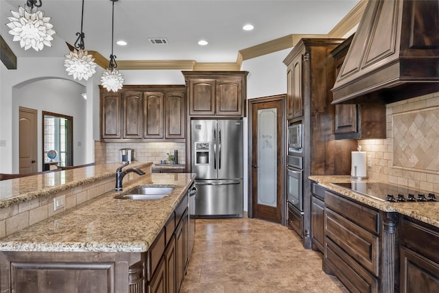 kitchen with a sink, premium range hood, stainless steel appliances, visible vents, and arched walkways