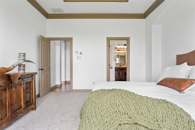 bedroom featuring carpet, ensuite bath, and ornamental molding