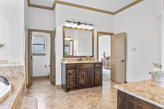 full bathroom with crown molding, toilet, a garden tub, and vanity